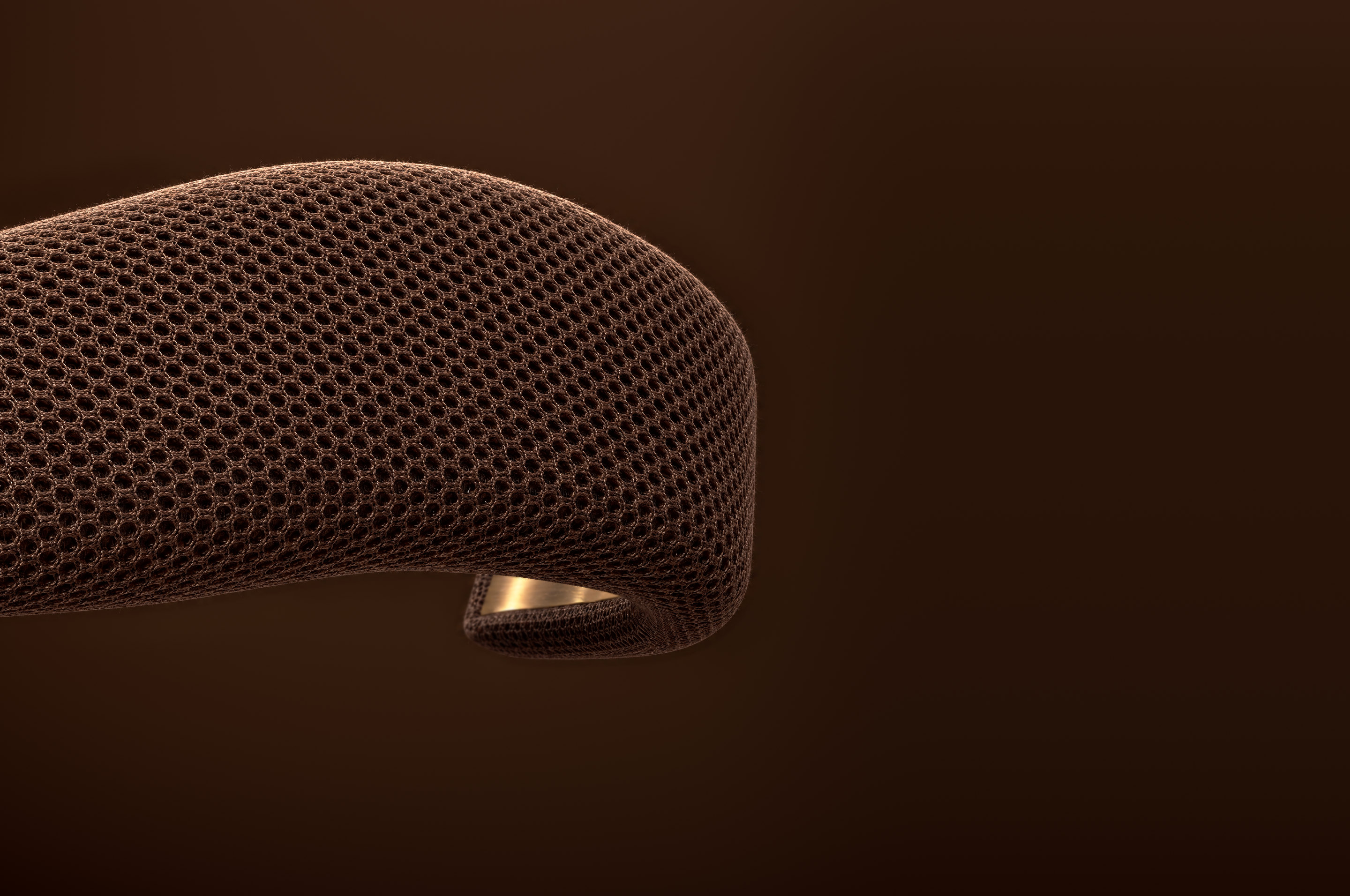 Helder, a curved band wrapped in 3D mesh with a brass plate inside